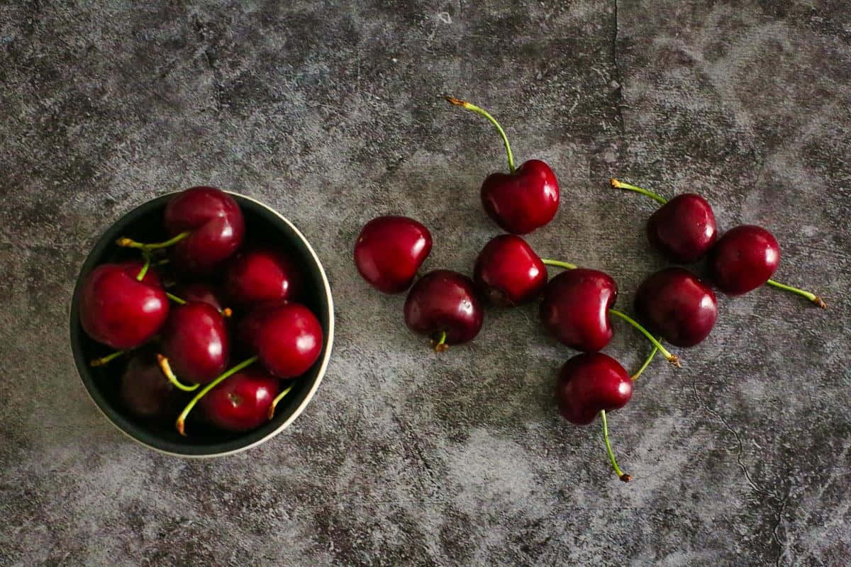 Fresh And Vibrant Red Cherries Wallpaper