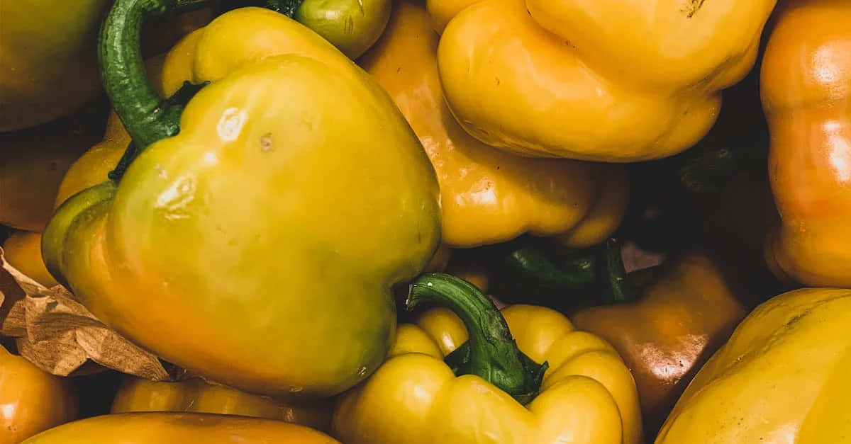 Fresh Yellow Bell Pepper On A Wooden Surface Wallpaper