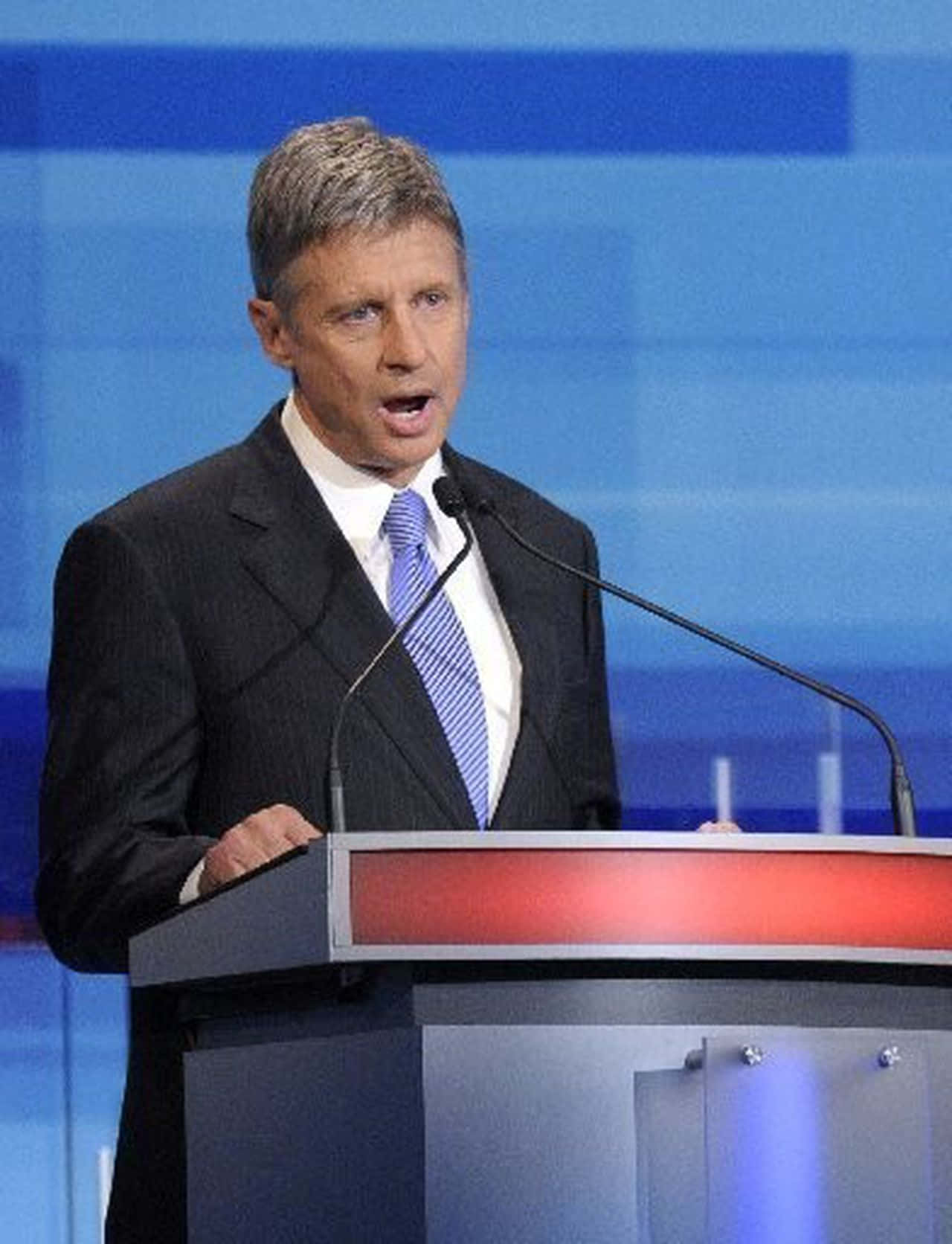 Gary Johnson Speaking Into A Blue Microphone Wallpaper