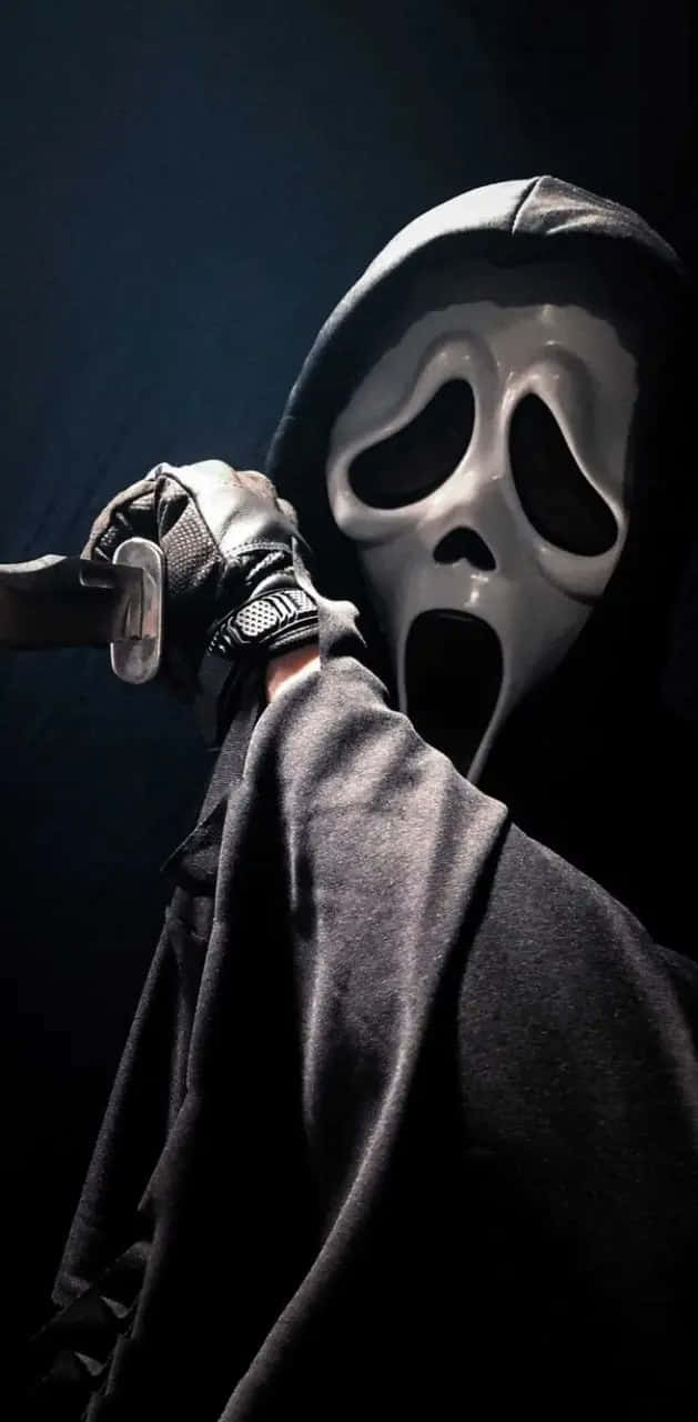 Ghostface Holding Knife Dark Backdrop Wallpaper