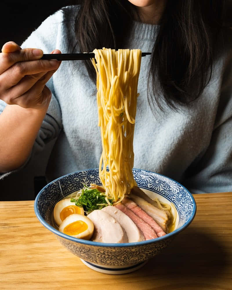 Girl Digging Out Ramen Noodles Wallpaper