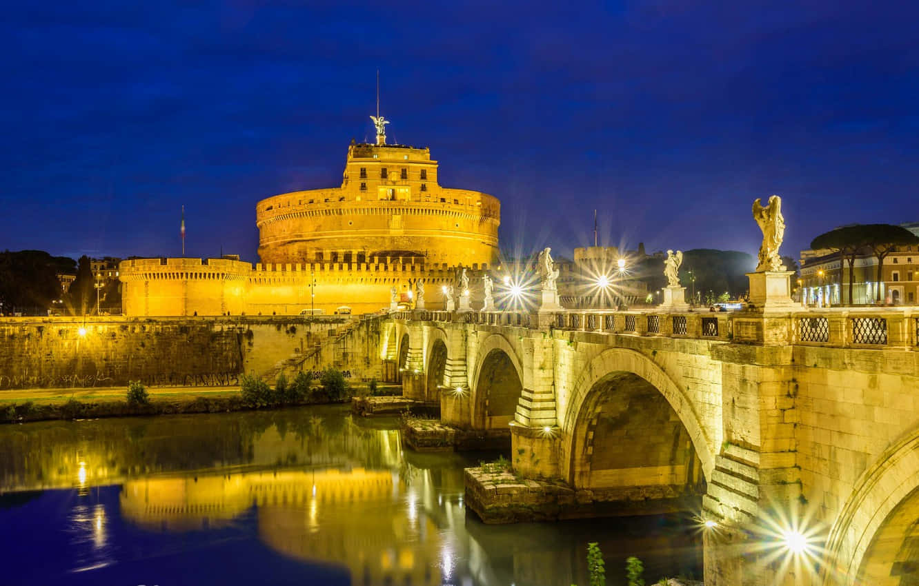 Gleaming Castel Santangelo At Night Wallpaper