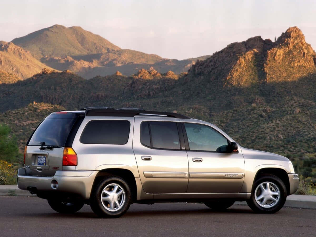 Gmc Envoy Suv On The Road Wallpaper