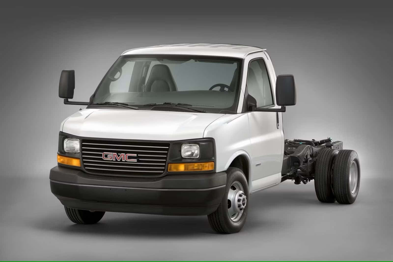 Gmc Savana Cargo Van On The Road Wallpaper