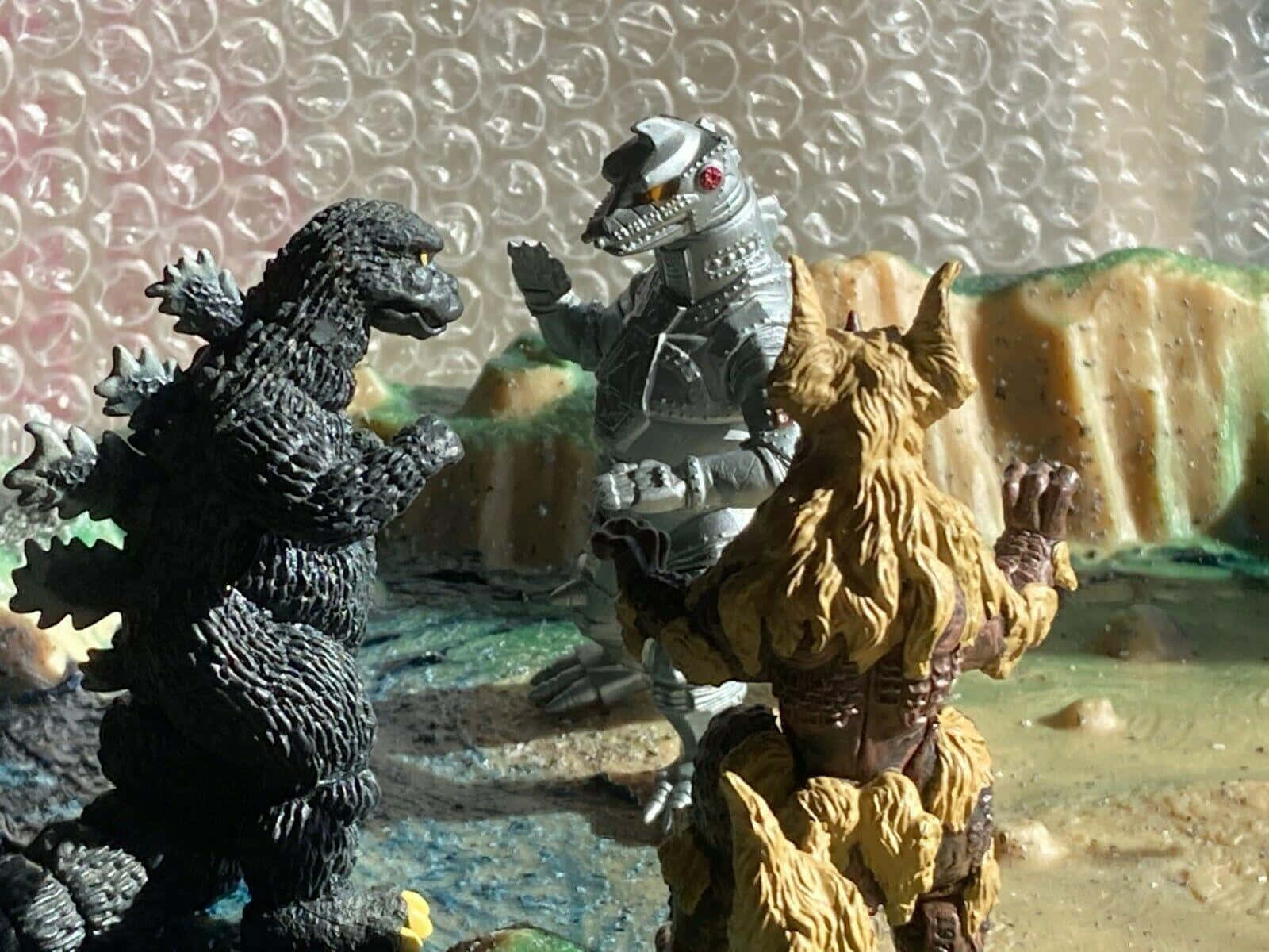 Godzillavs King Caesarand Mechagodzilla Toy Battle Wallpaper