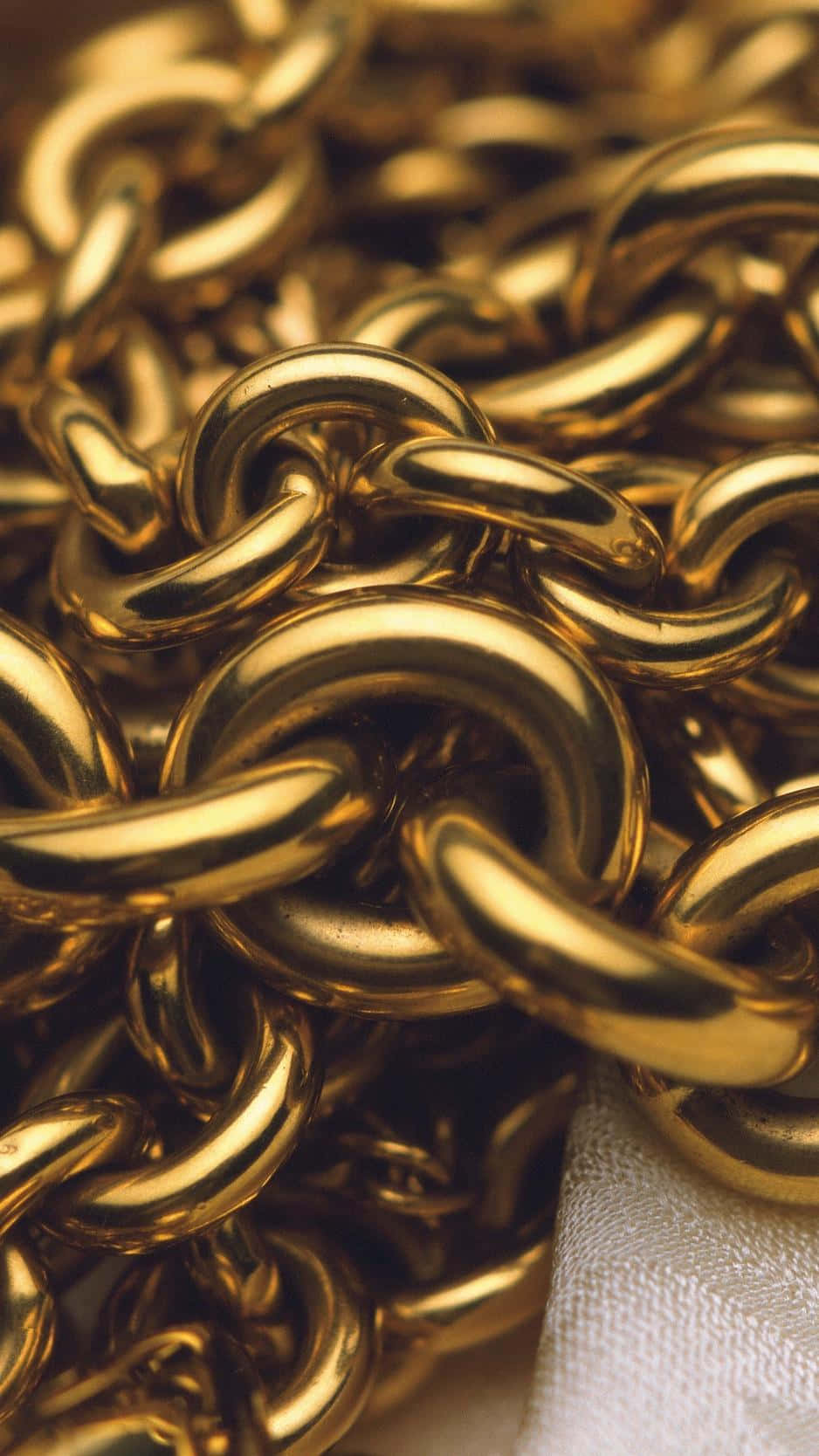 Gold Chain On A White Cloth Wallpaper