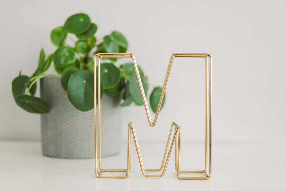 Gold Metal Letter M Decoration Wallpaper