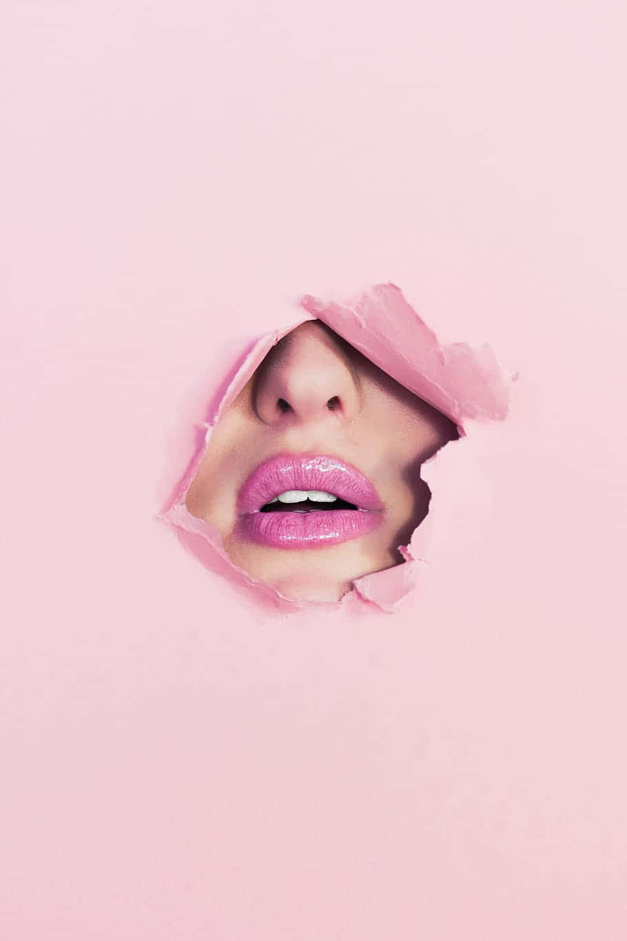 Gorgeous Woman Applying Stunning Pink Lipstick Wallpaper