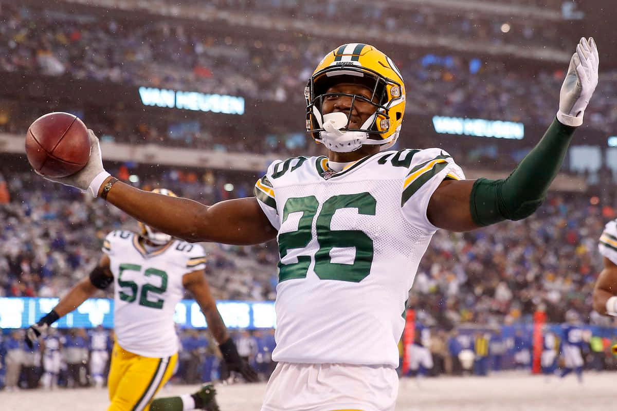 Green Bay Player Celebratingwith Football Wallpaper