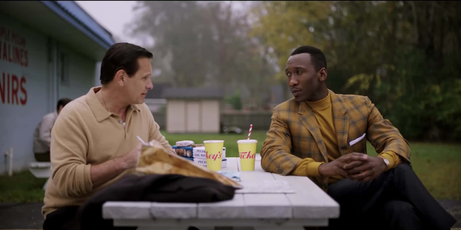 Green Book Movie Scene Outdoor Diner Conversation Wallpaper