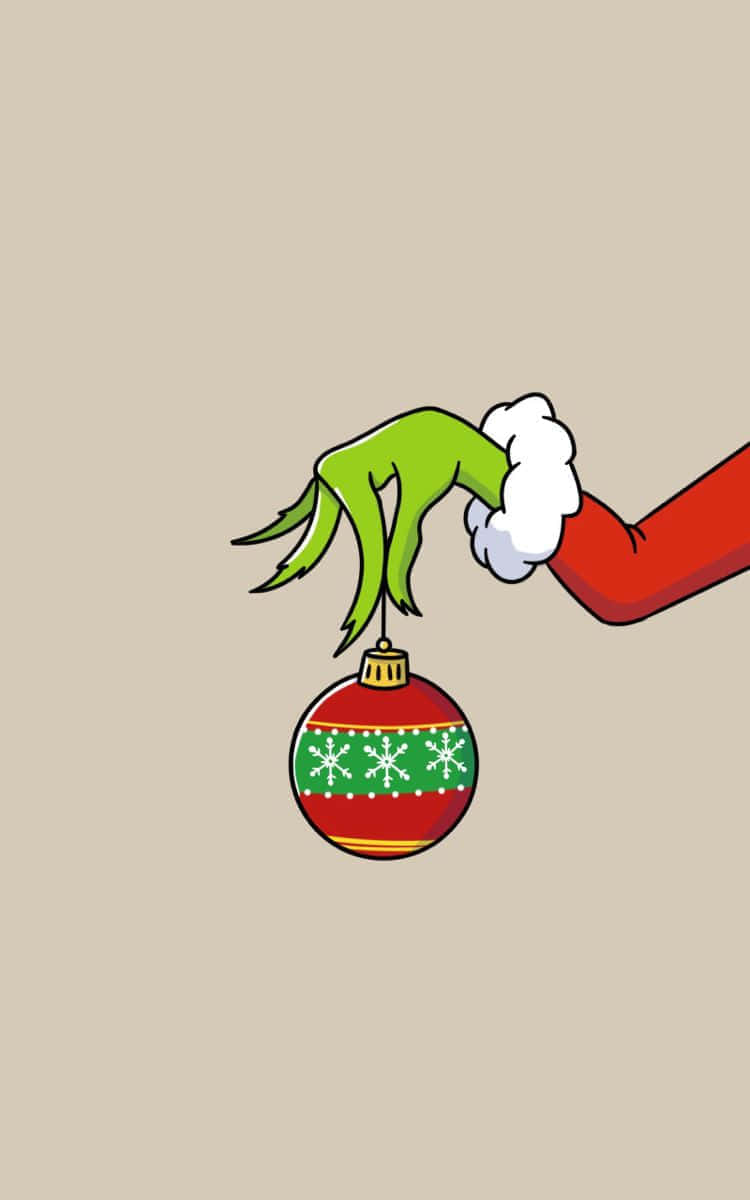 Grinch Hand Holding Christmas Ornament Wallpaper