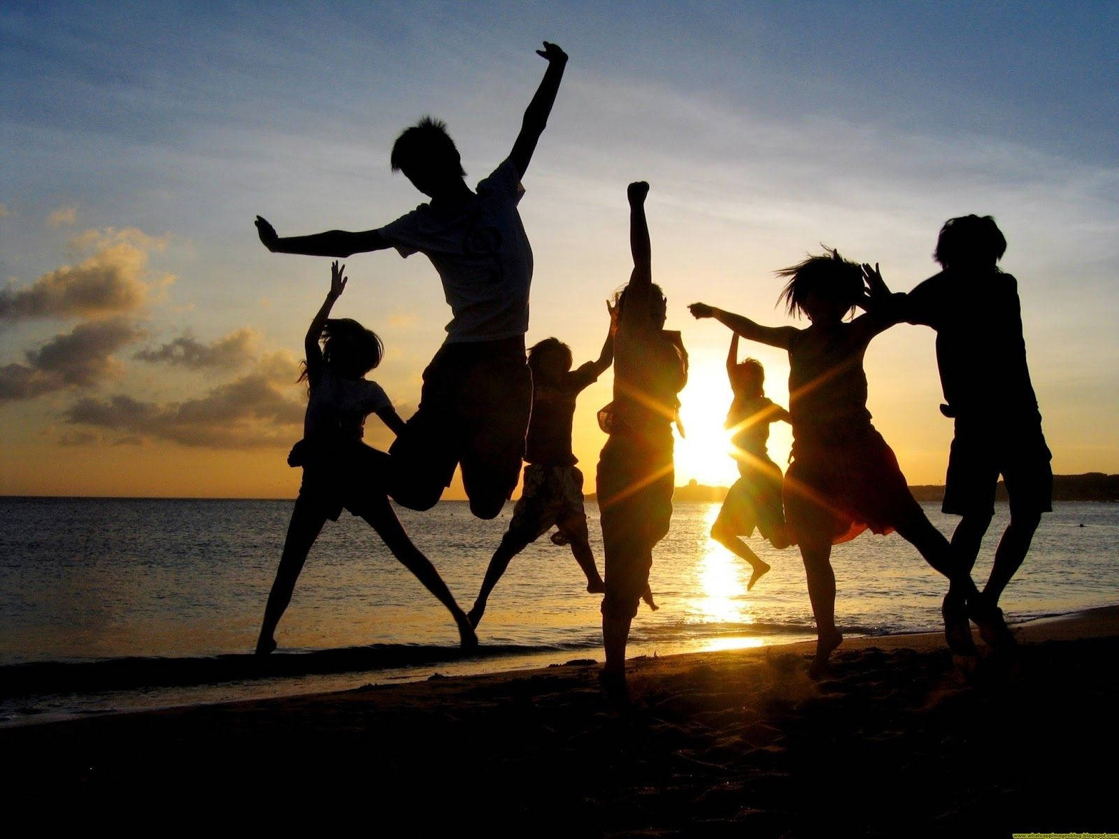 Group Silhouette Jump Shot At Beach Wallpaper