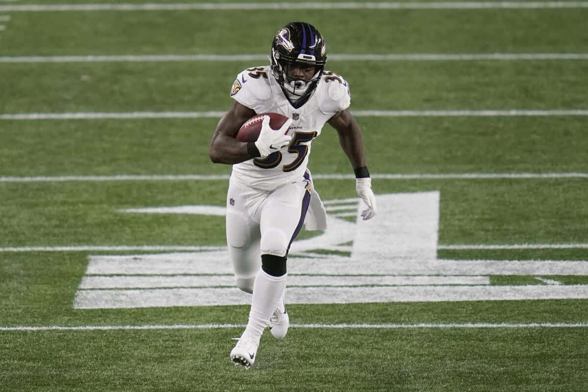 Gus Edwards Baltimore Ravens Running Back Action Wallpaper