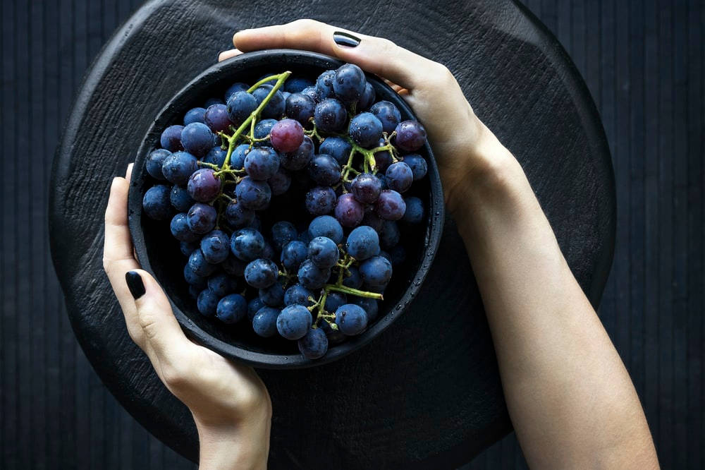 Hands Holding Grapes Wallpaper