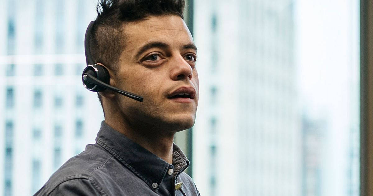 Handsome Rami Malek Wearing Headset Wallpaper