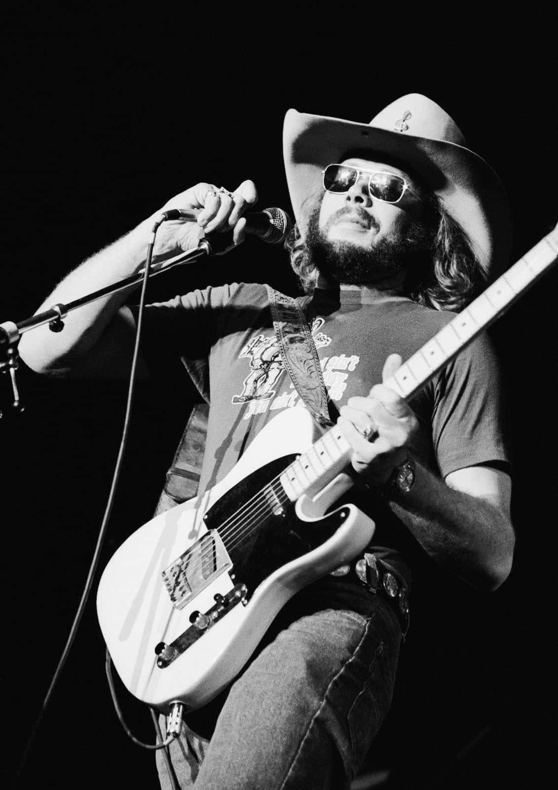 Hank Williams Jr Performing At A Live Music Concert Wallpaper