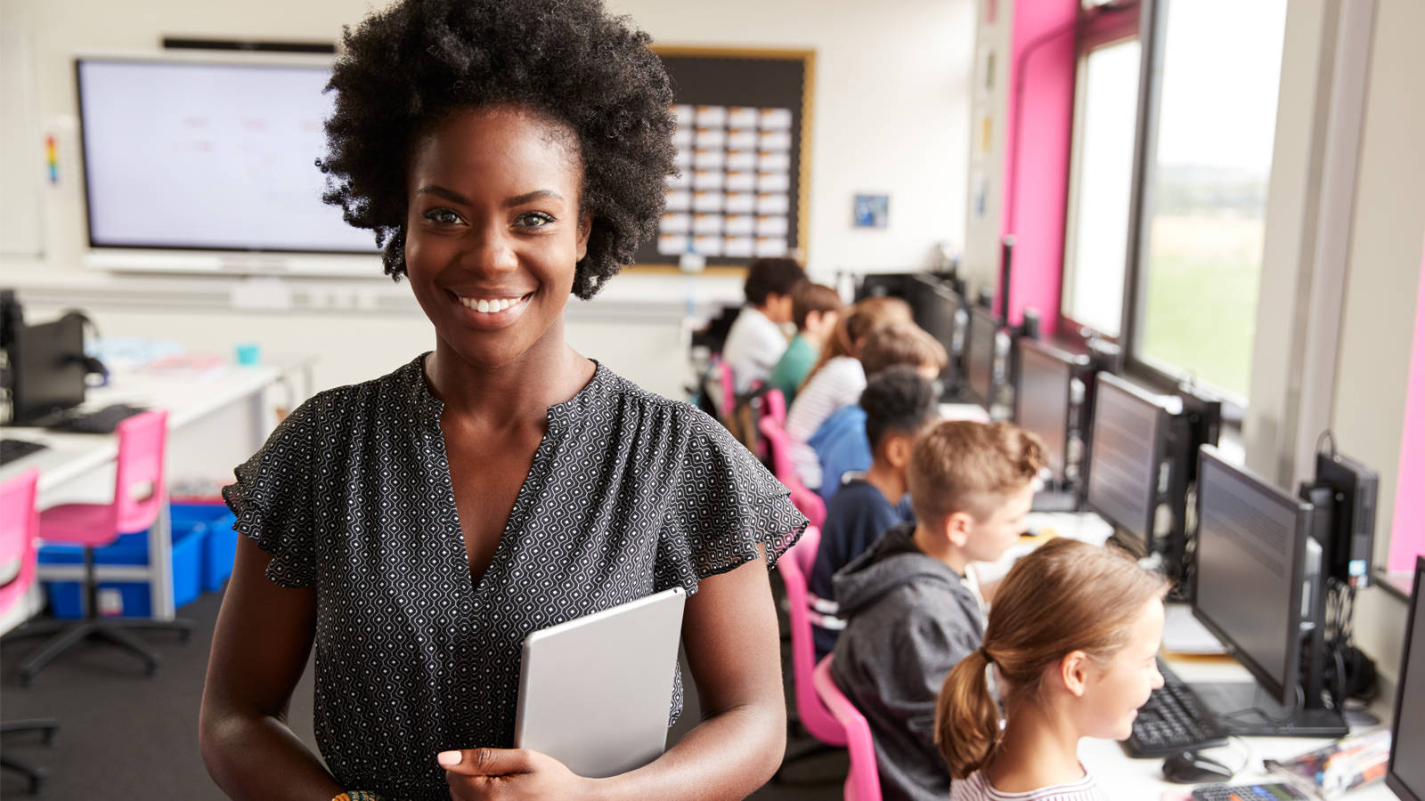 Happy African Teacher In Computer Class Wallpaper