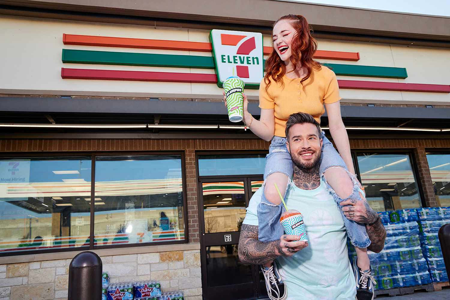 Happy Couple Enjoying Slurpees Outside7 Eleven Wallpaper