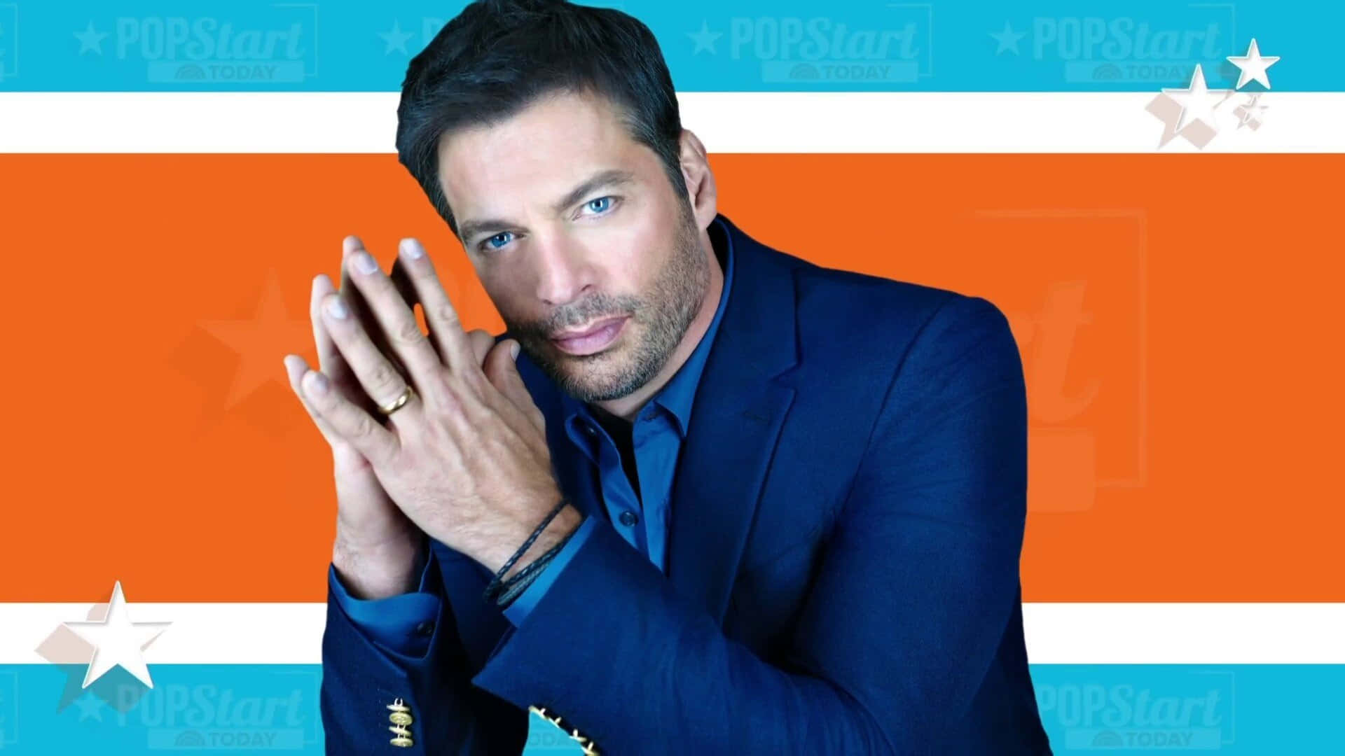 Harry Connick Jr. In A Dapper Suit, Standing Confidently Against A Simple Background Wallpaper