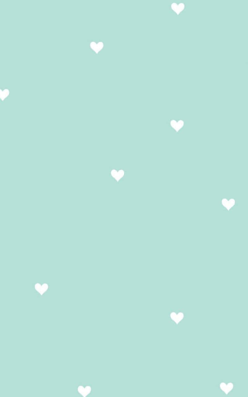 Heart Cushions Of Pastel Mint Green Color In Strewn On A White Background. Wallpaper