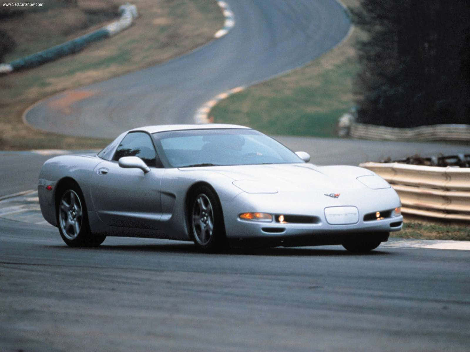 High-speed Red Chevrolet Corvette C5 On The Road Wallpaper