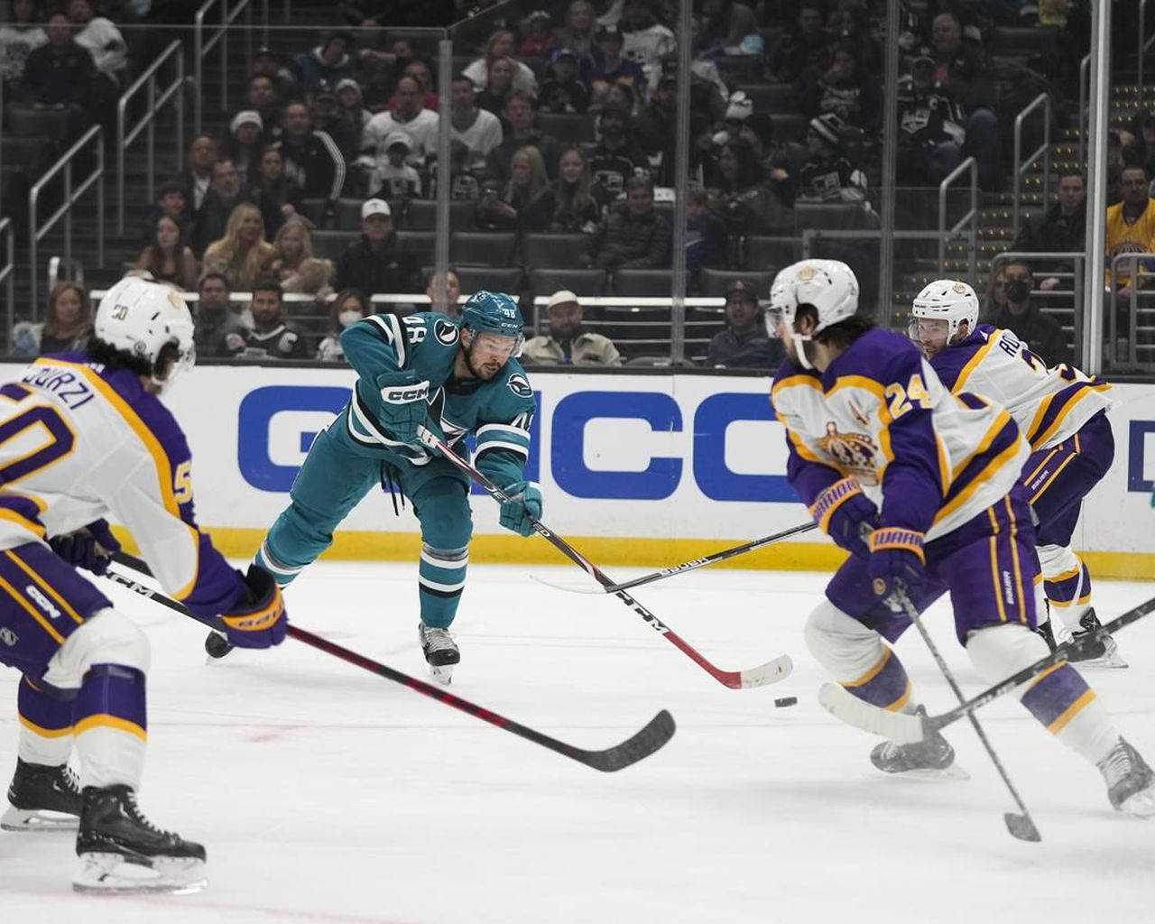 Hockey Pro Tomas Hertl Skillfully Maneuvering Against Defenders On The Ice. Wallpaper