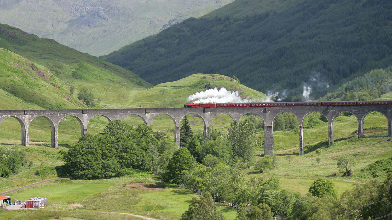 Hogwarts Express Chugging Through The Magical Landscape Wallpaper