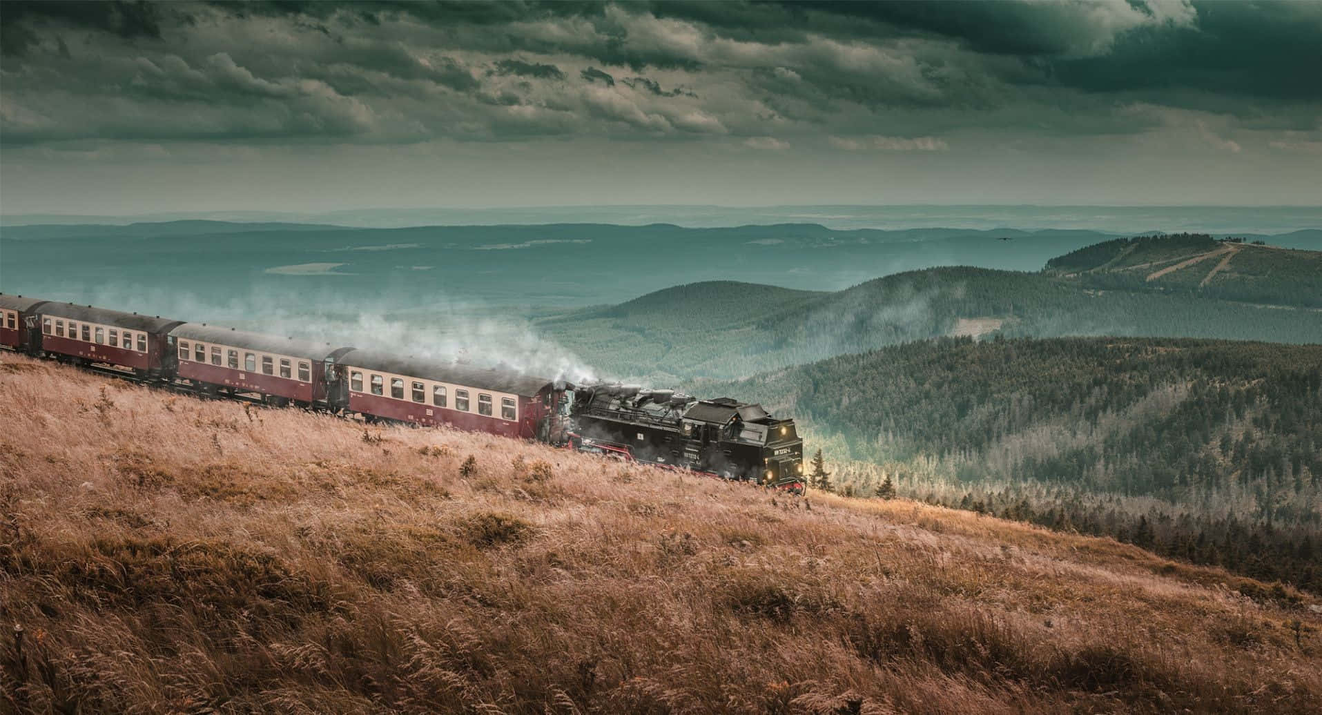 Hogwarts Express Steaming Through Scenic Landscape Wallpaper