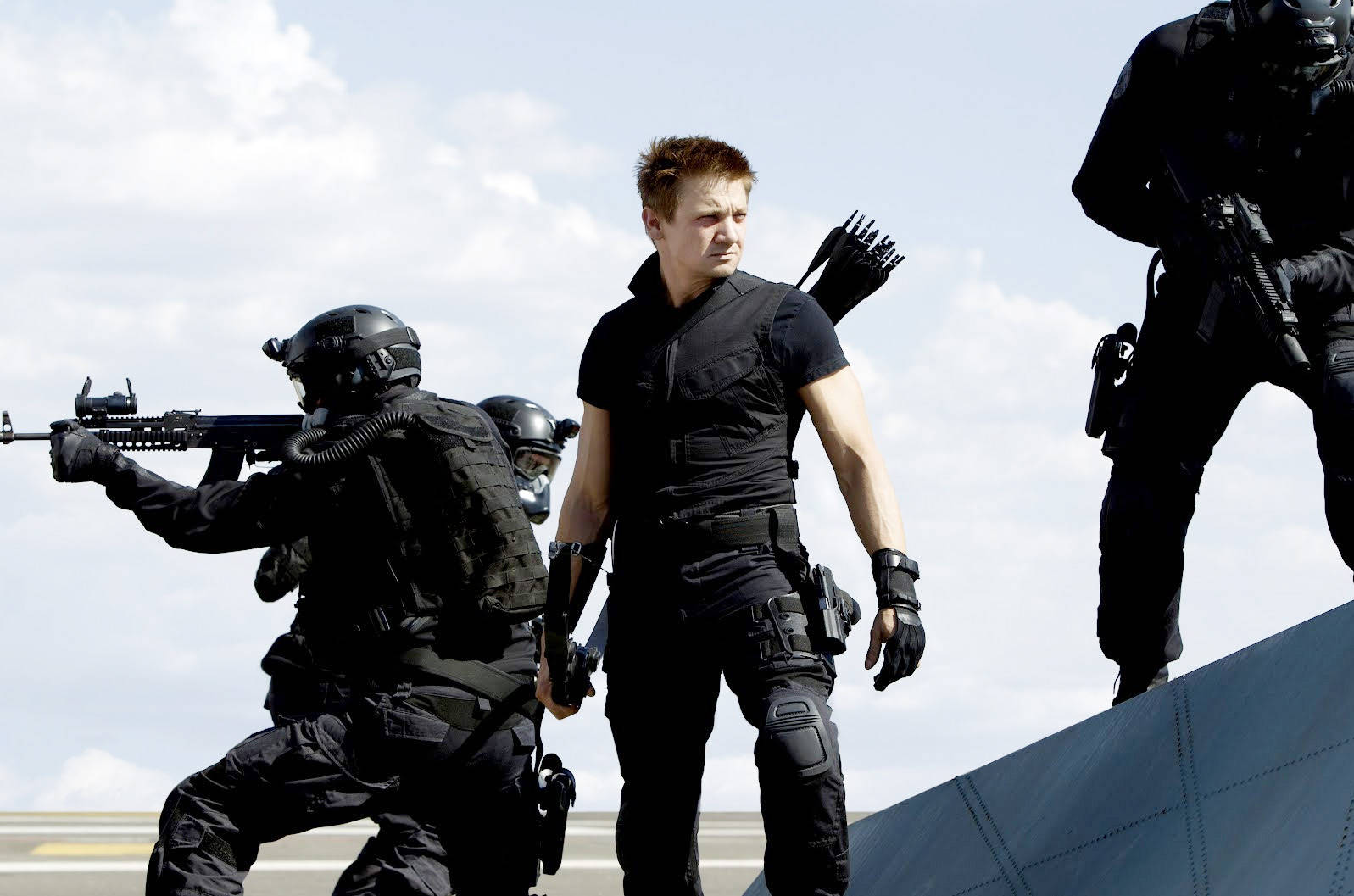 Hollywood Actor Jeremy Renner Posing With His Squad Wallpaper