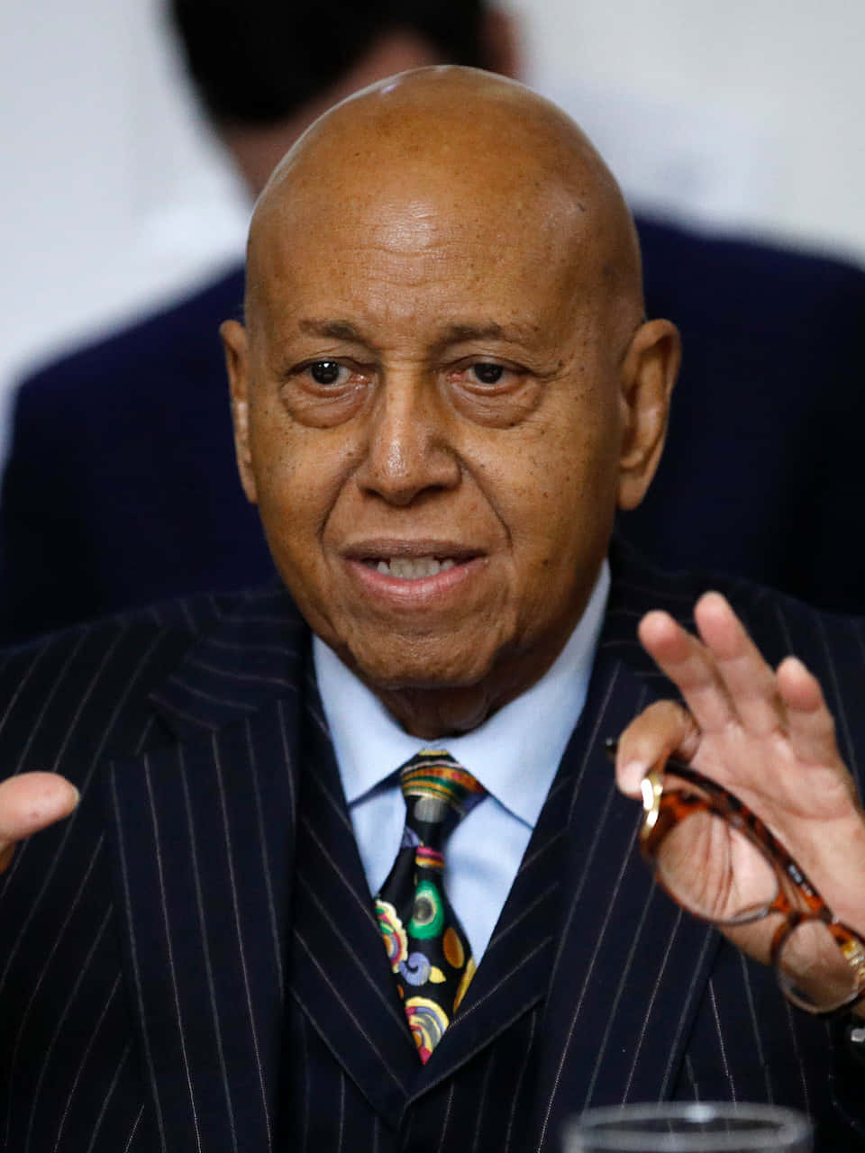 Honorable Alcee Hastings Posing With Glasses In Hand Wallpaper