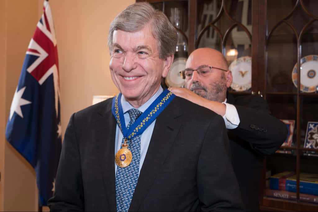 Honorable Senator Roy Blunt Holding A Prestigious Medal Wallpaper