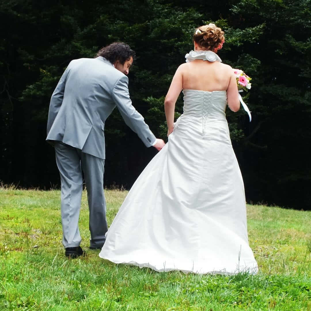 Husband And Wife Holding Hands On Grass Wallpaper