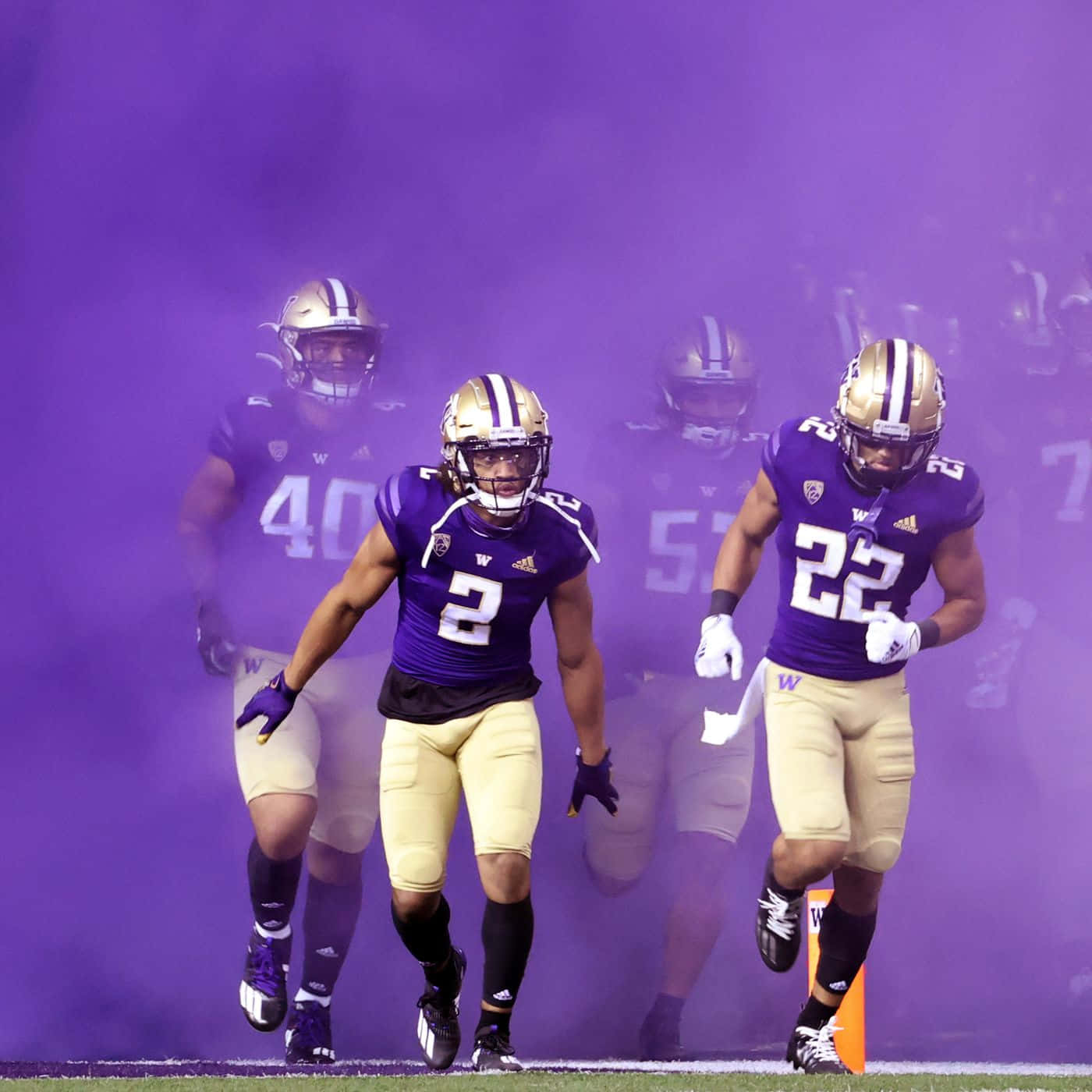 Huskies Football Team Emerging Through Smoke Wallpaper