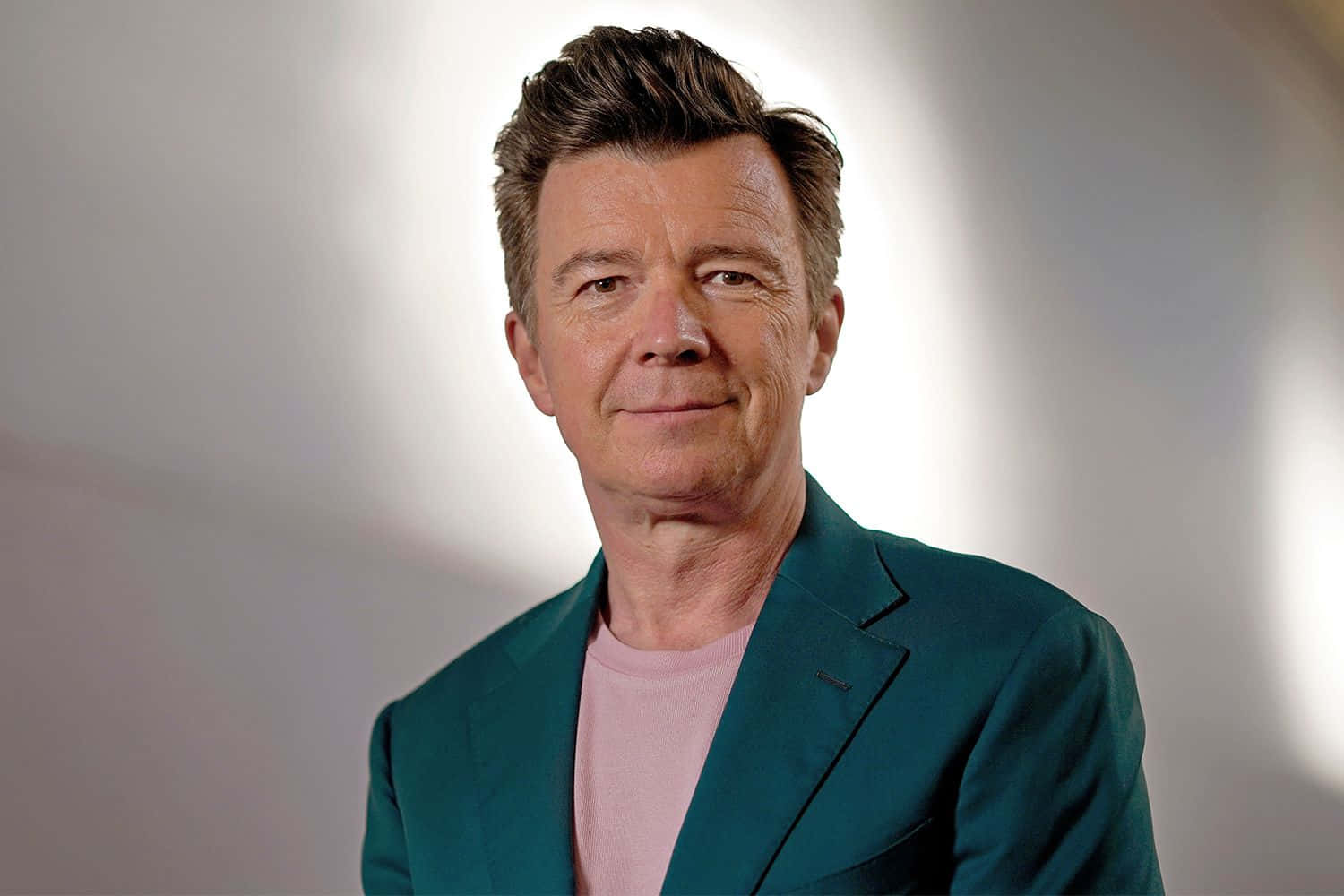 Iconic Singer Rick Astley At A Performance Wallpaper