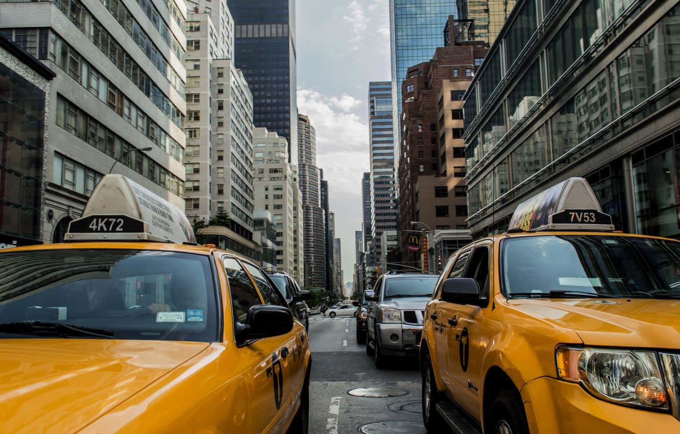 Iconic Yellow Cab In The City Streets Wallpaper