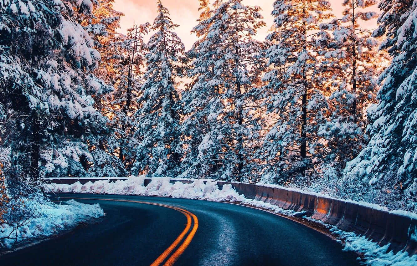 Icy Road Amidst A Snowy Landscape Wallpaper