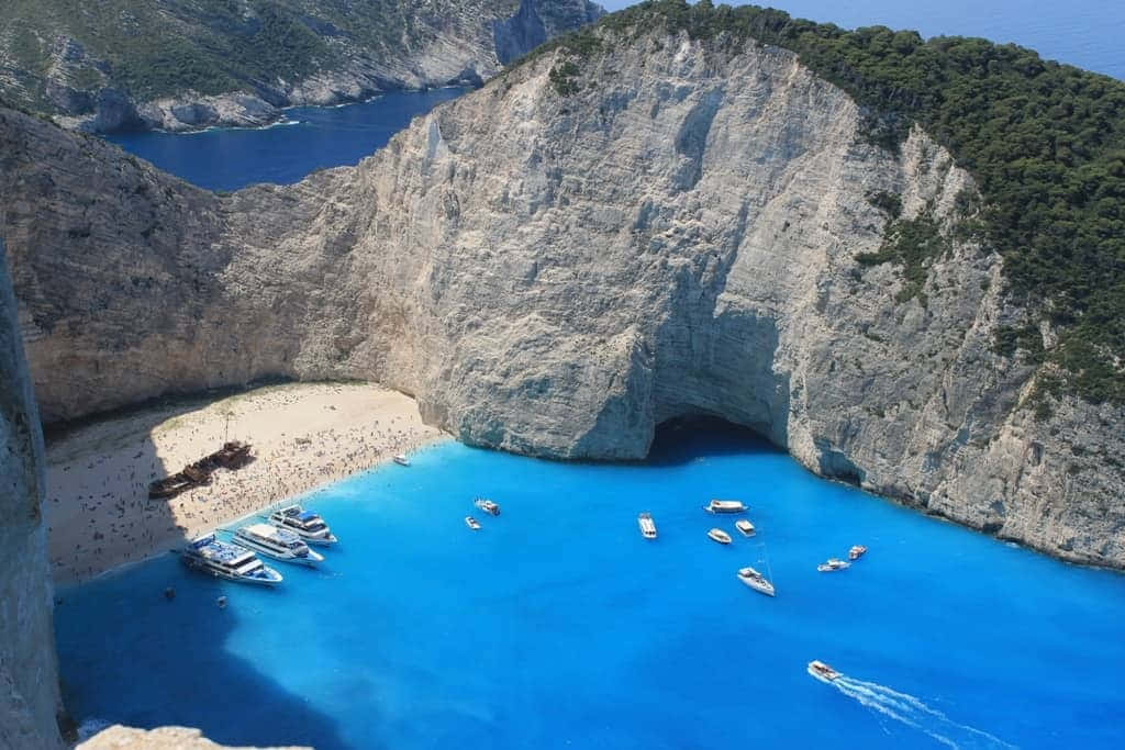 Idyllic Greek Island With Clear Blue Sea Wallpaper