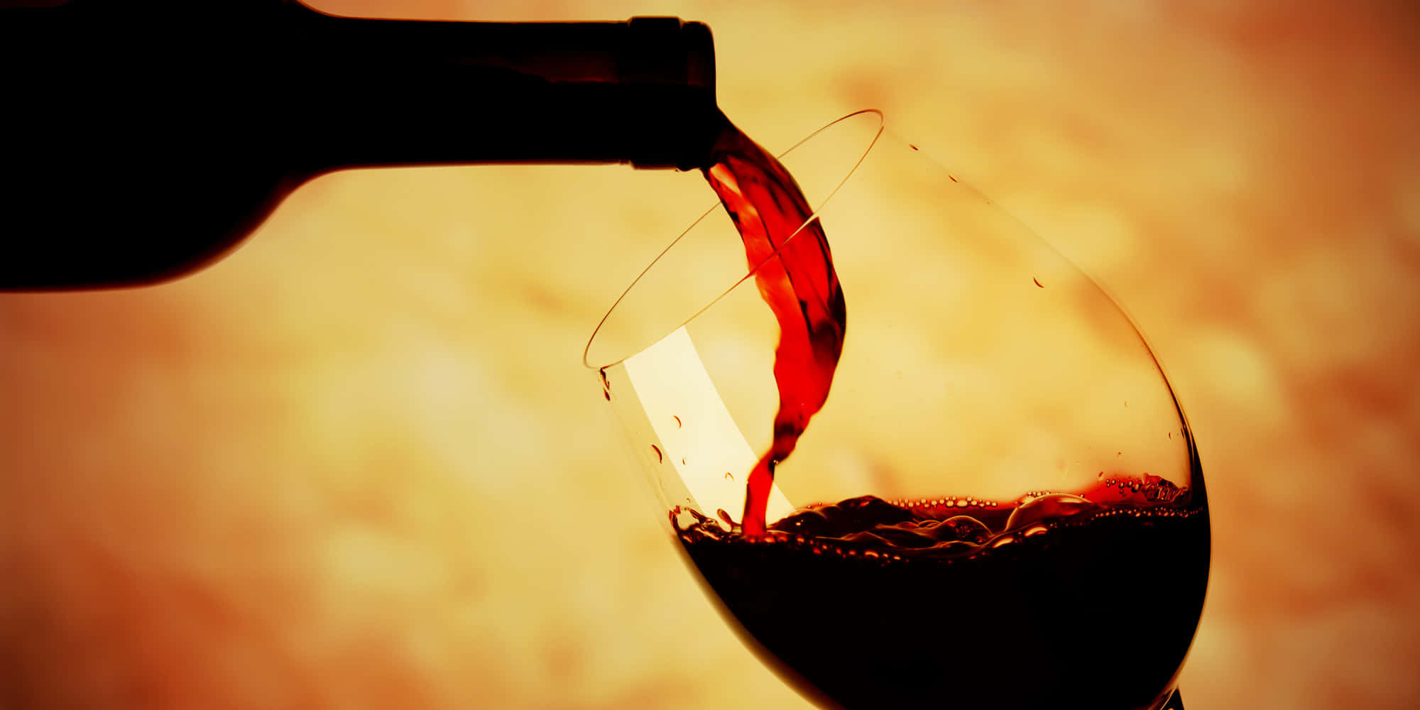 Image A Glass Of Black Wine Glistening In The Light Wallpaper