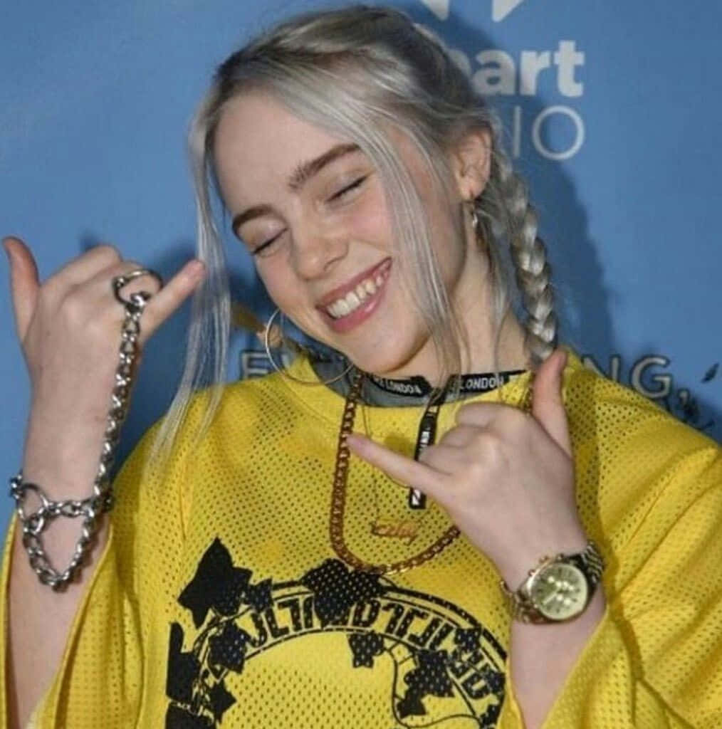 Image Billie Eilish Showing Her Signature Toothy Smile Wallpaper