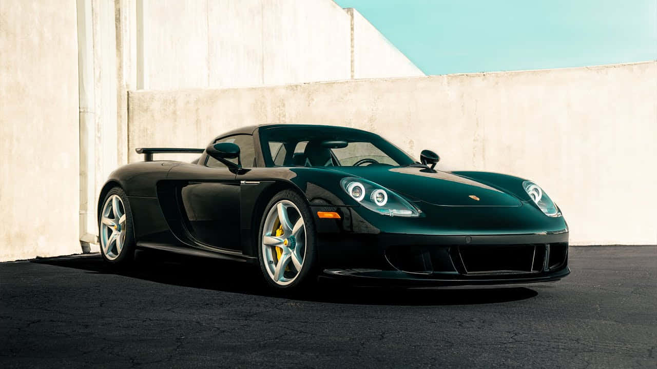 Immaculate Design Of Porsche Carrera Gt Against Evening Skyline. Wallpaper