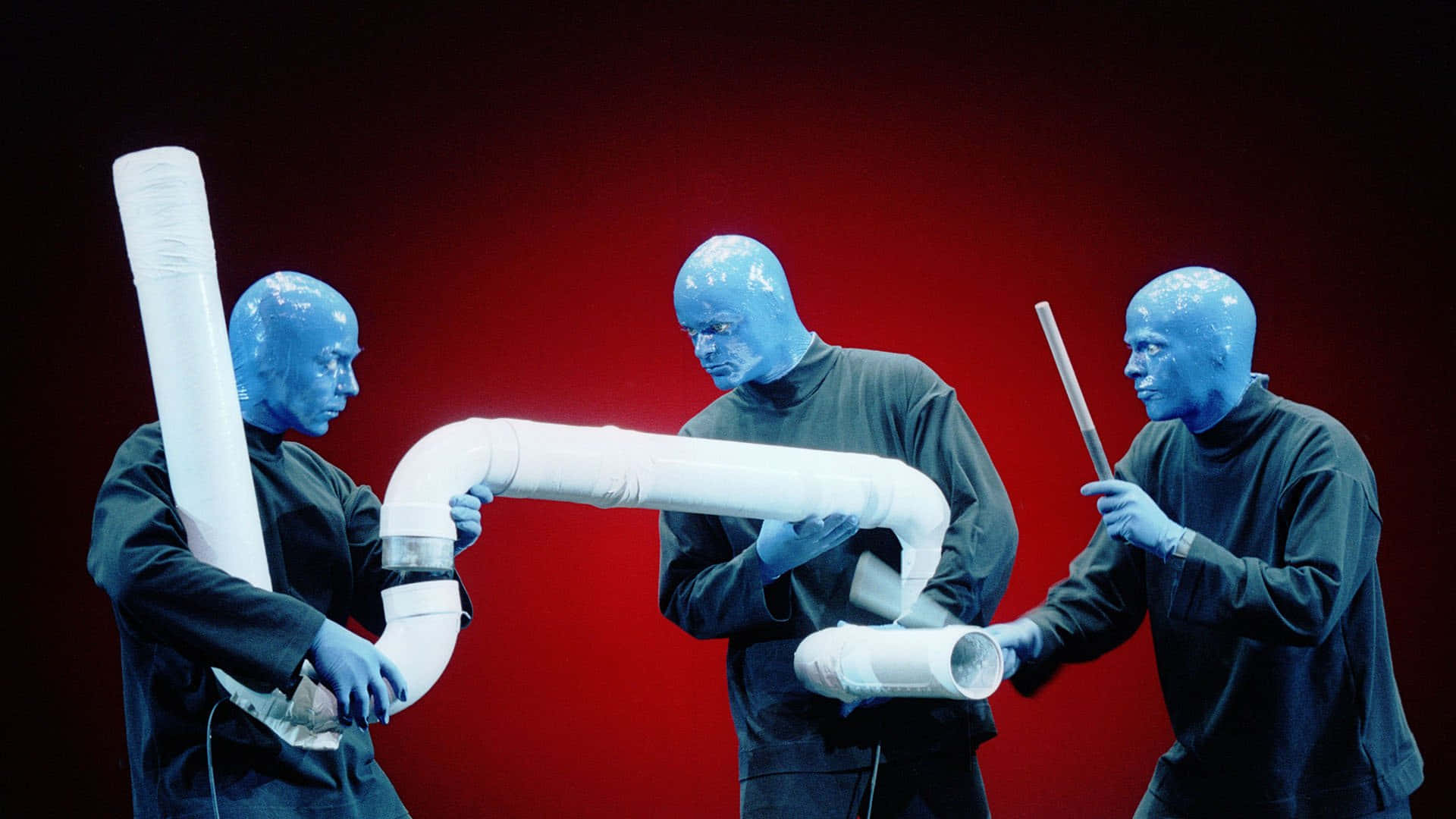 Incredible Artists From The Blue Man Group Performing In Front Of A Captive Audience Wallpaper