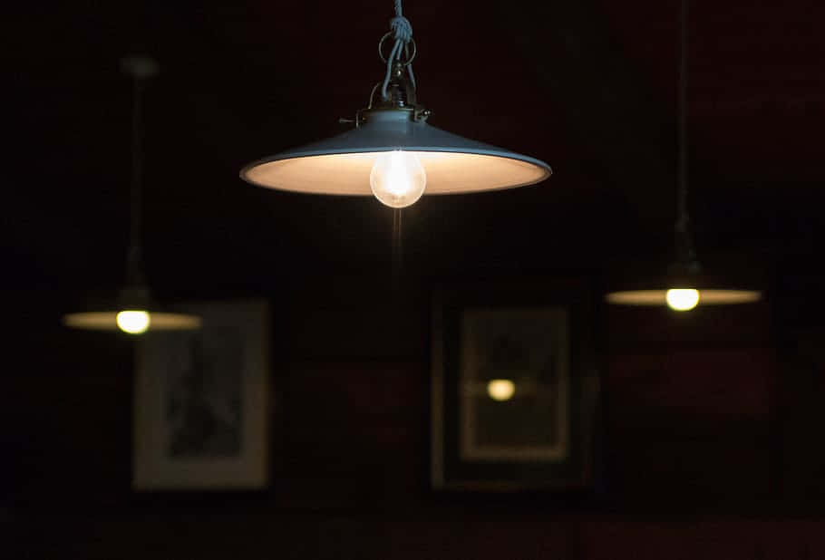 Industrial Pendant Lightingin Dark Room Wallpaper