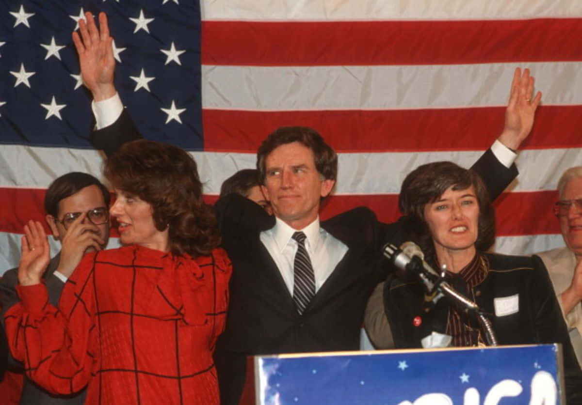 Influential Politician Gary Hart Waving To Crowd Wallpaper