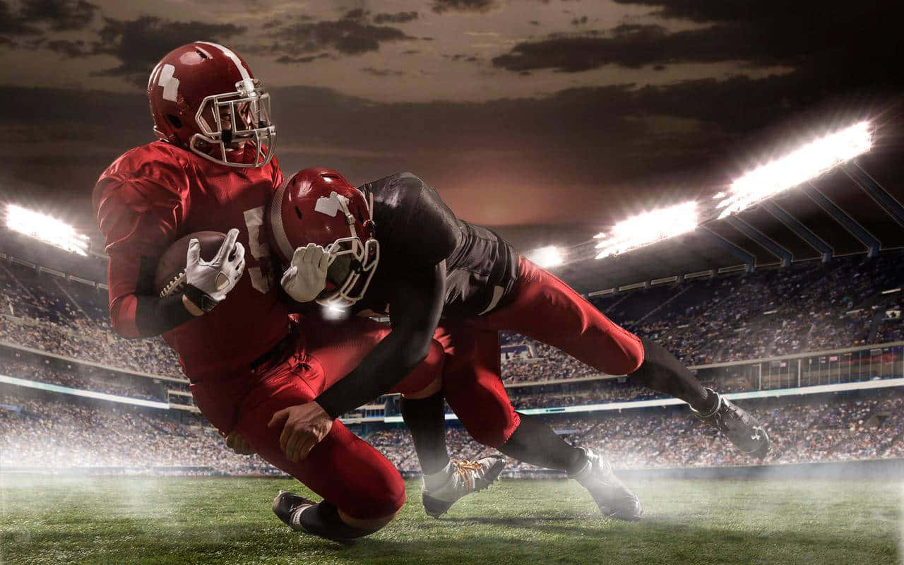 Intense_ Nighttime_ Football_ Tackle.jpg Wallpaper