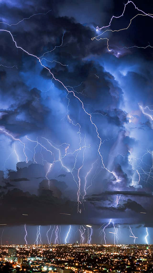 Intense Nighttime Lightning Over Cityscape Wallpaper