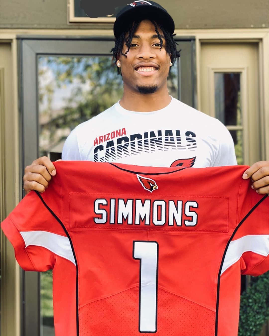 Isaiah Simmons Holding Cardinals Jersey Wallpaper