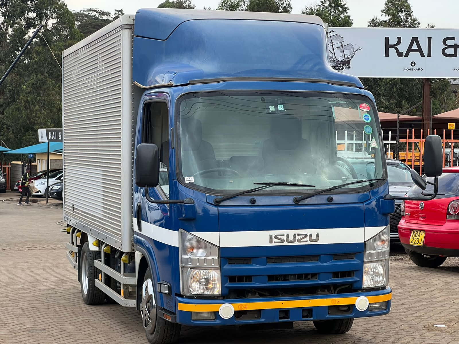 Isuzu Elf Blue Truck Parked Wallpaper