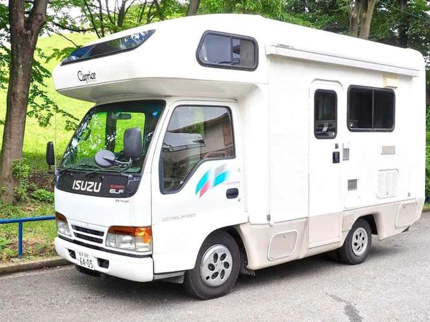 Isuzu Elf Camper Van Parked Outdoors Wallpaper