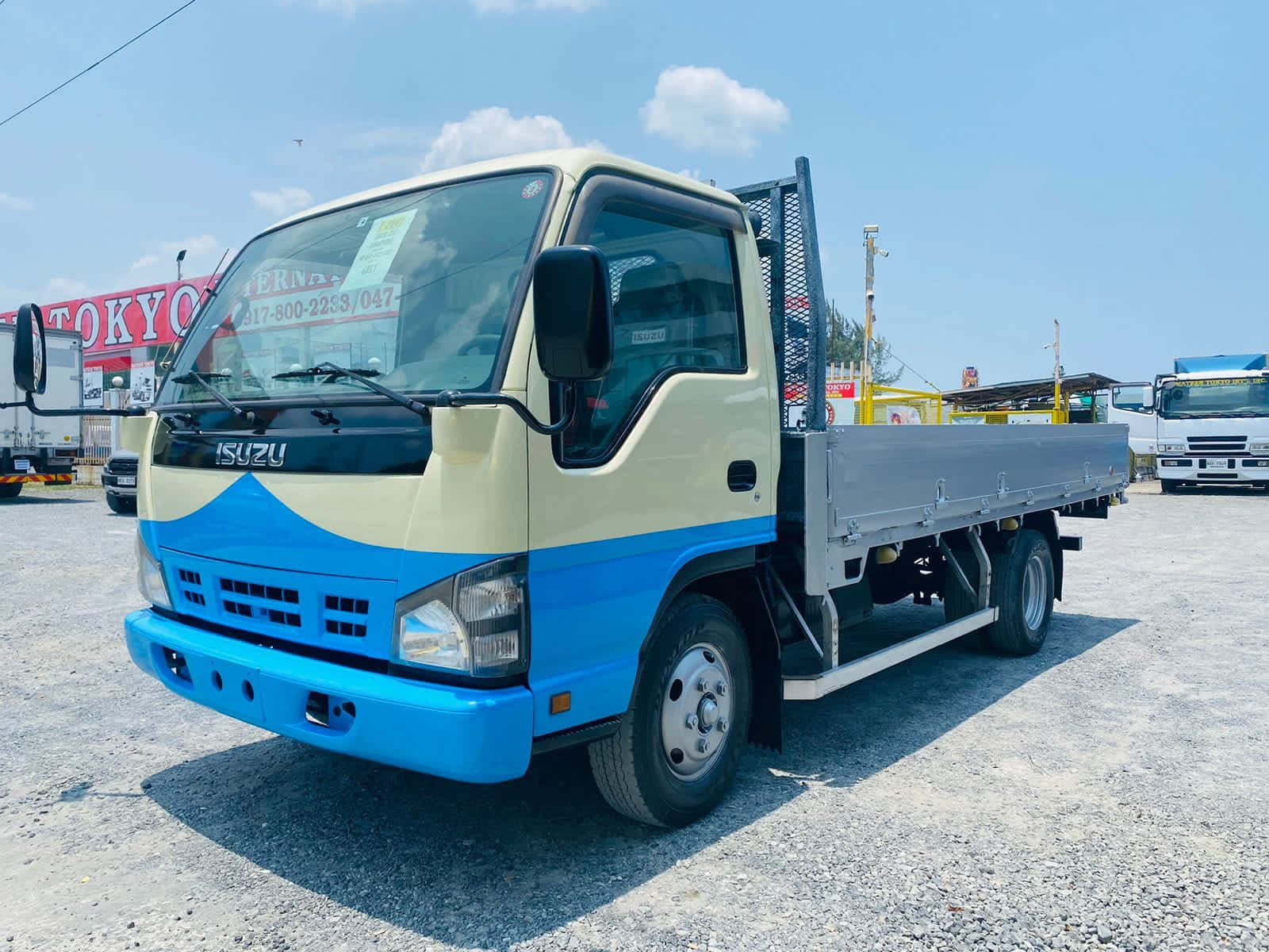 Isuzu Elf Flatbed Truck Parked Wallpaper