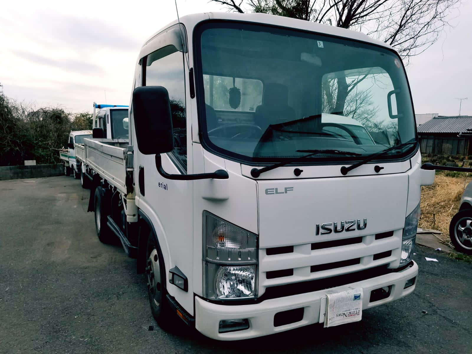 Isuzu Elf Flatbed Truck Parked Wallpaper